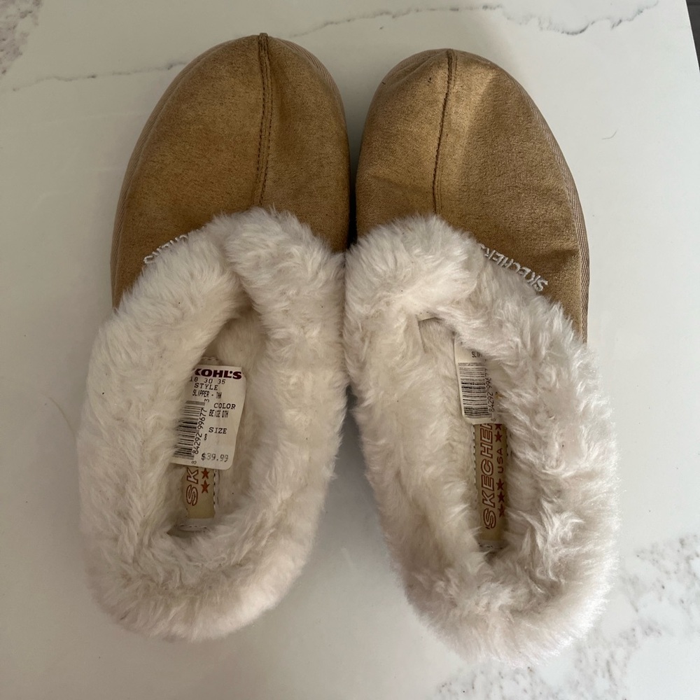 NWT women’s tan Skechers slippers. Warm white lining. Size 8.